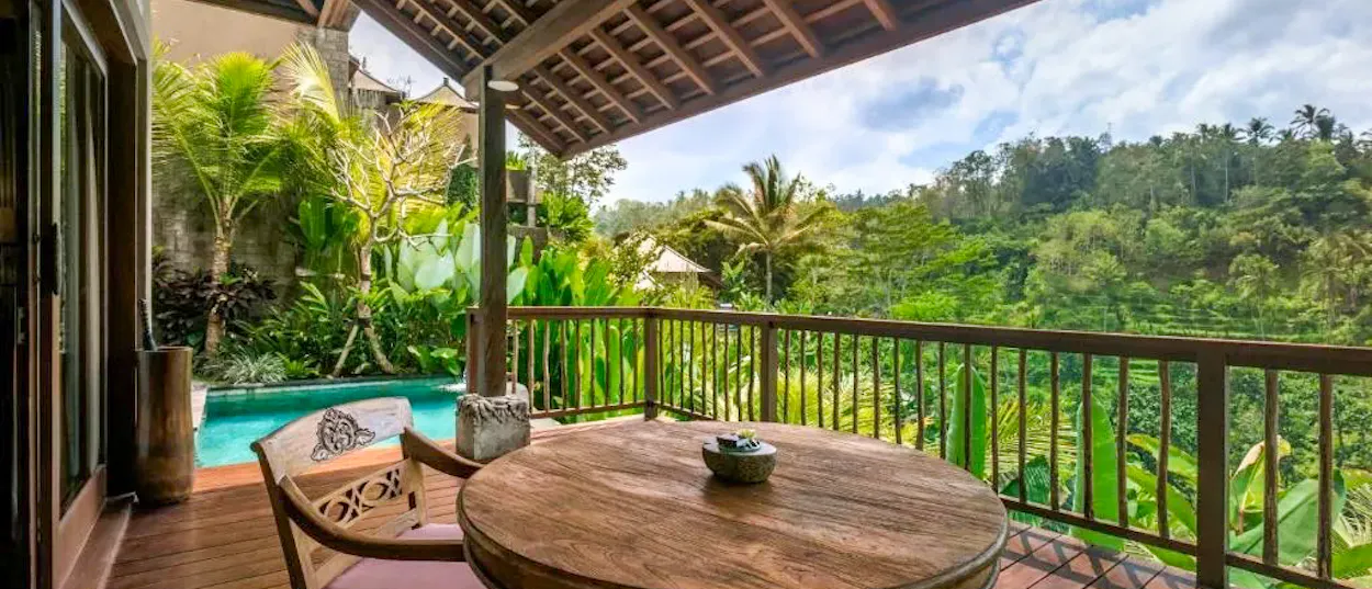 A luxurious pool villa balcony overlooking a lush jungle valley in Ubud, Bali.