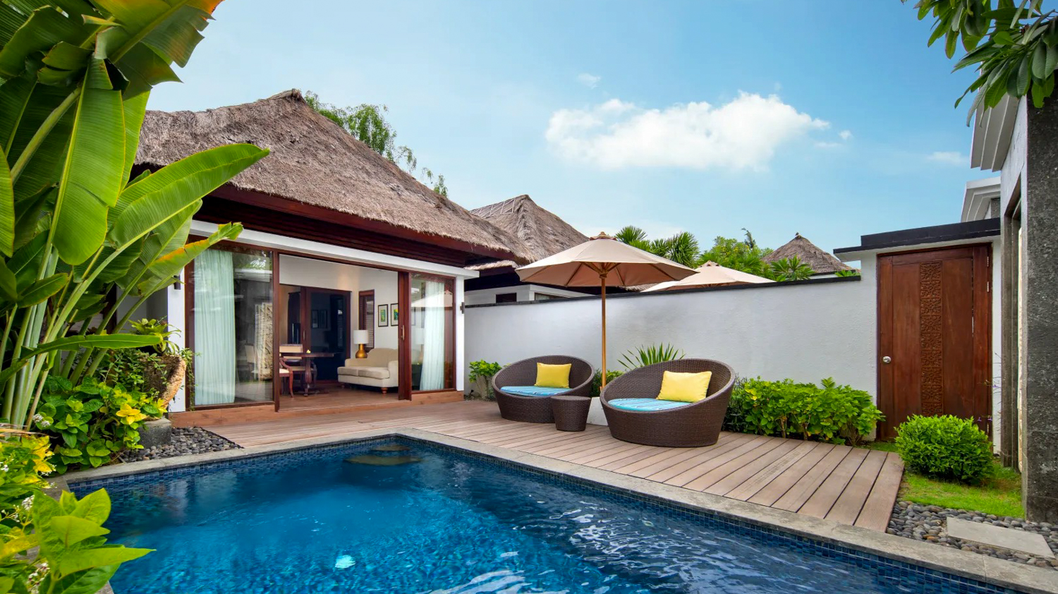 A luxurious private villa in Nusa Lembongan with a clear blue swimming pool and comfortable outdoor lounge chairs.