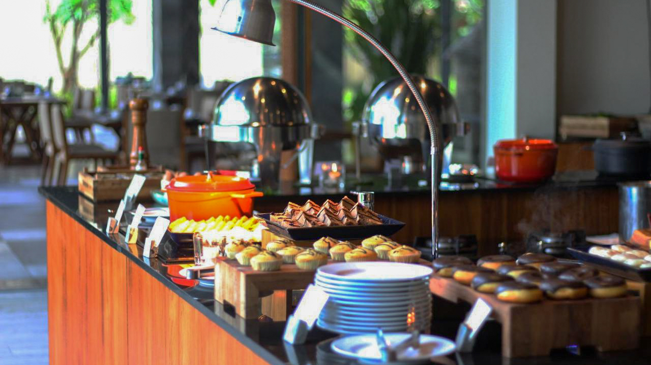 A lavish breakfast buffet with pastries, fruits, and hot dishes at Katamaran Resort, Lombok.