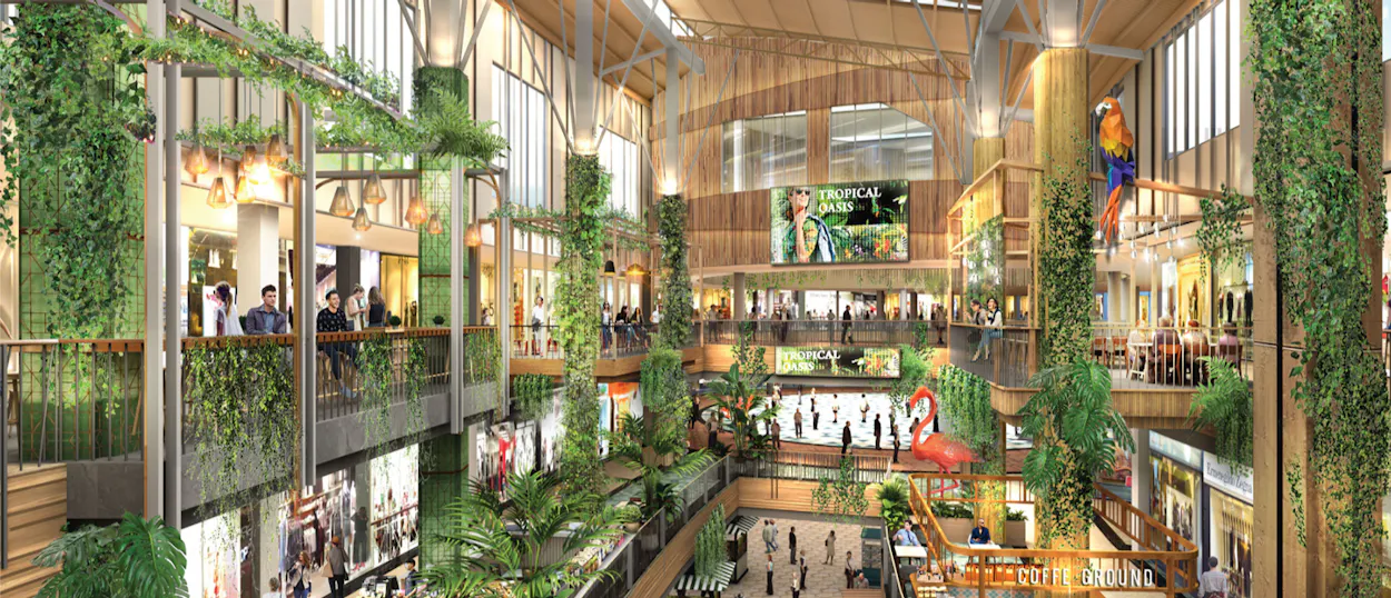 A bustling, multi-level shopping mall in Phuket, adorned with lush greenery and vibrant tropical decor.