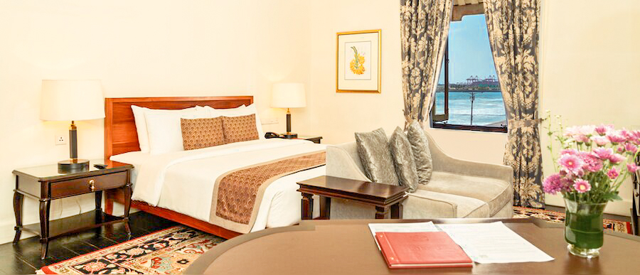 A luxurious hotel room in Colombo with a comfortable bed, elegant furnishings, and a stunning ocean view.