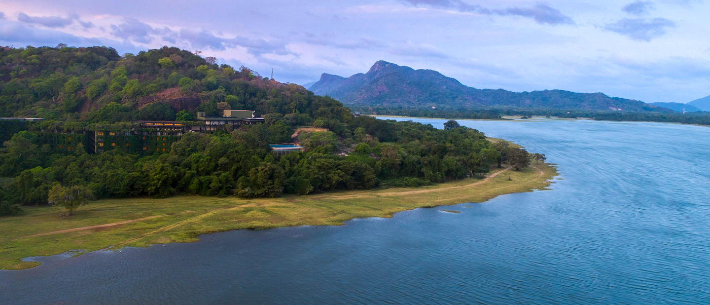 Heritance Kandalama resort blends into lush green hills overlooking the vast Kandalama Lake, Sri Lanka.