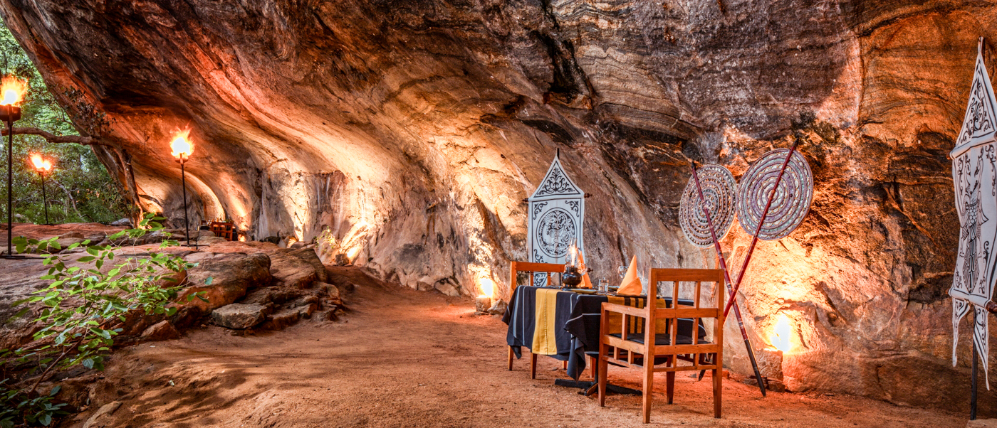 Romantic cave dinner setup with warm lighting and decorative screens in Sigiriya, Sri Lanka.