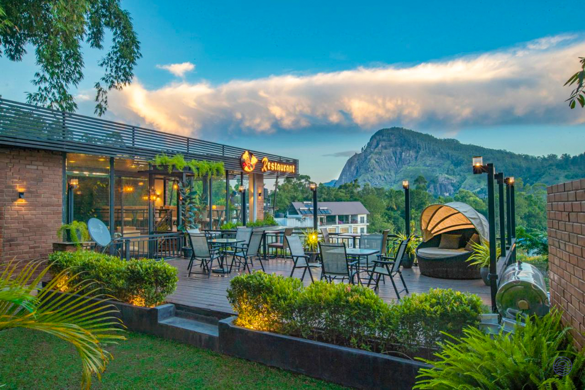Scenic outdoor patio at Ella Heritage offering dining and lounge seating with Ella Rock views.