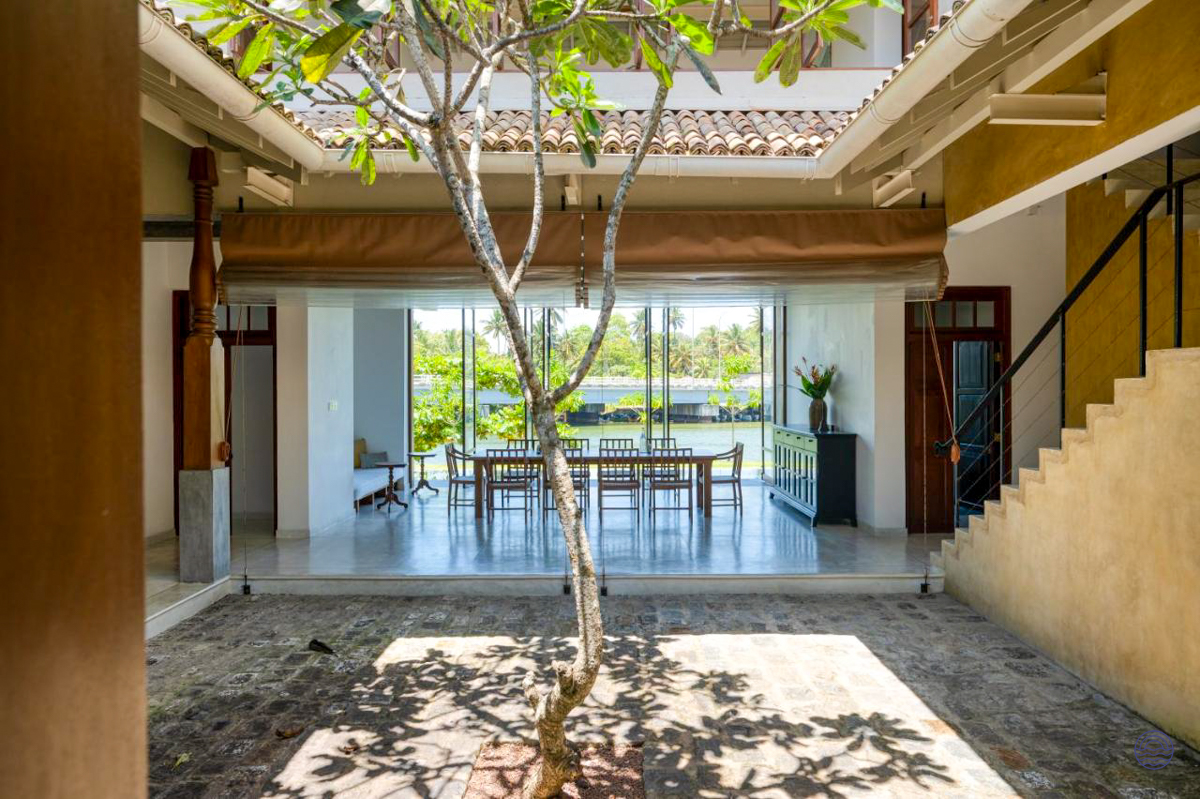Serene courtyard and dining area with a beautiful lagoon view at Sitara Villa, Weligama.