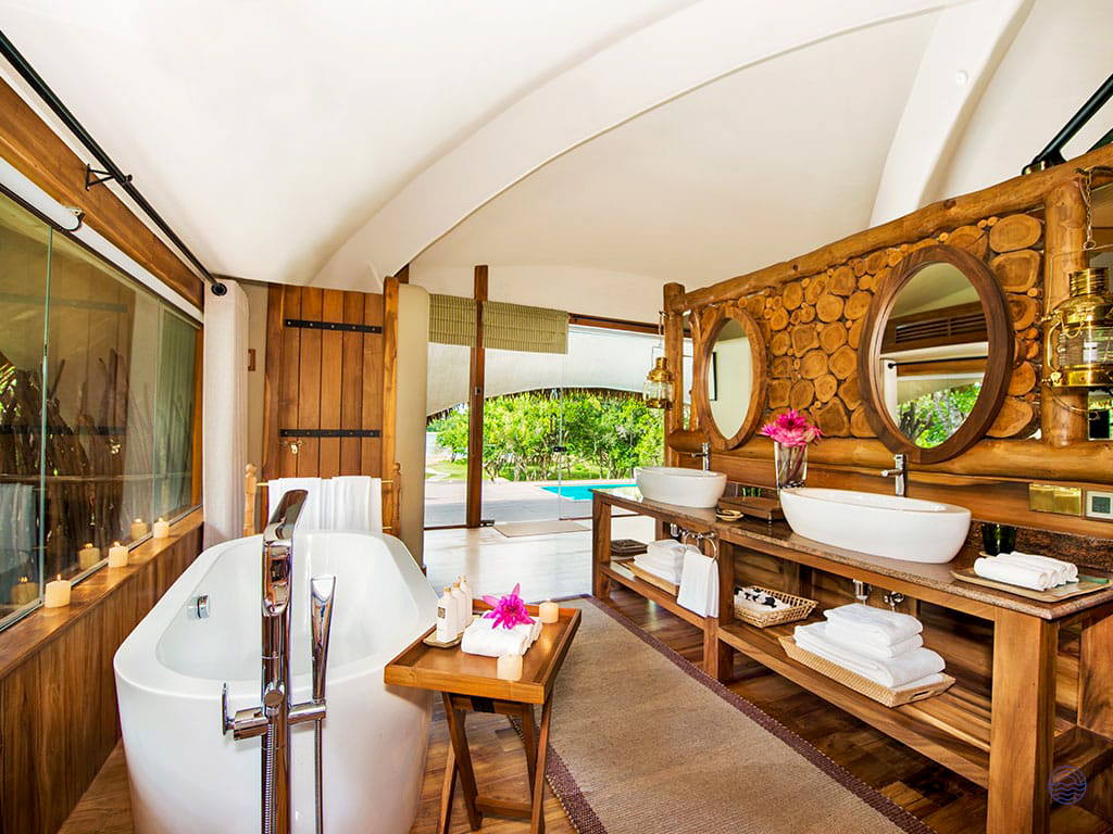 Luxurious bathroom at Uga Chena Huts, Yala, featuring a freestanding tub and private plunge pool.