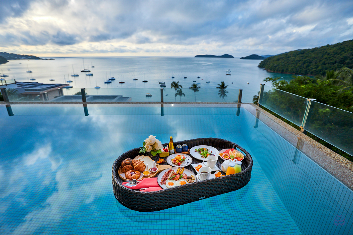 Enjoy a delicious floating breakfast in an infinity pool with panoramic views of Phuket's beautiful bay.