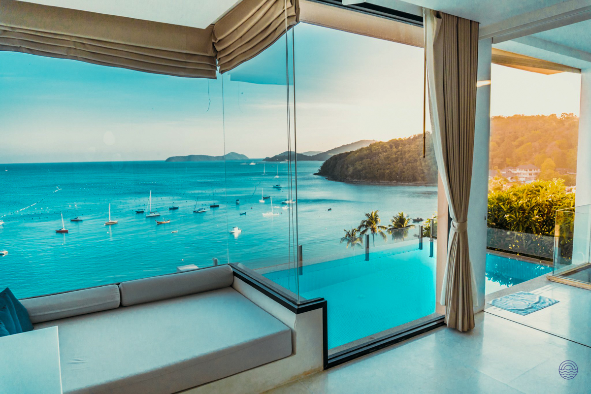 Stunning ocean views from a luxurious Phuket villa with a private infinity pool and sun lounge.