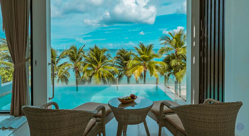 Enjoying the stunning ocean views from a luxurious beachfront villa in Phuket with a private pool.