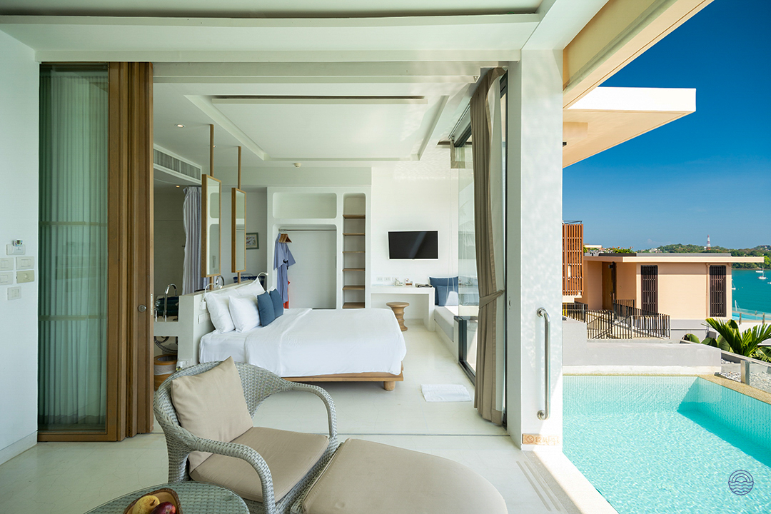 Luxurious villa bedroom with a private infinity pool overlooking the stunning Phuket ocean.