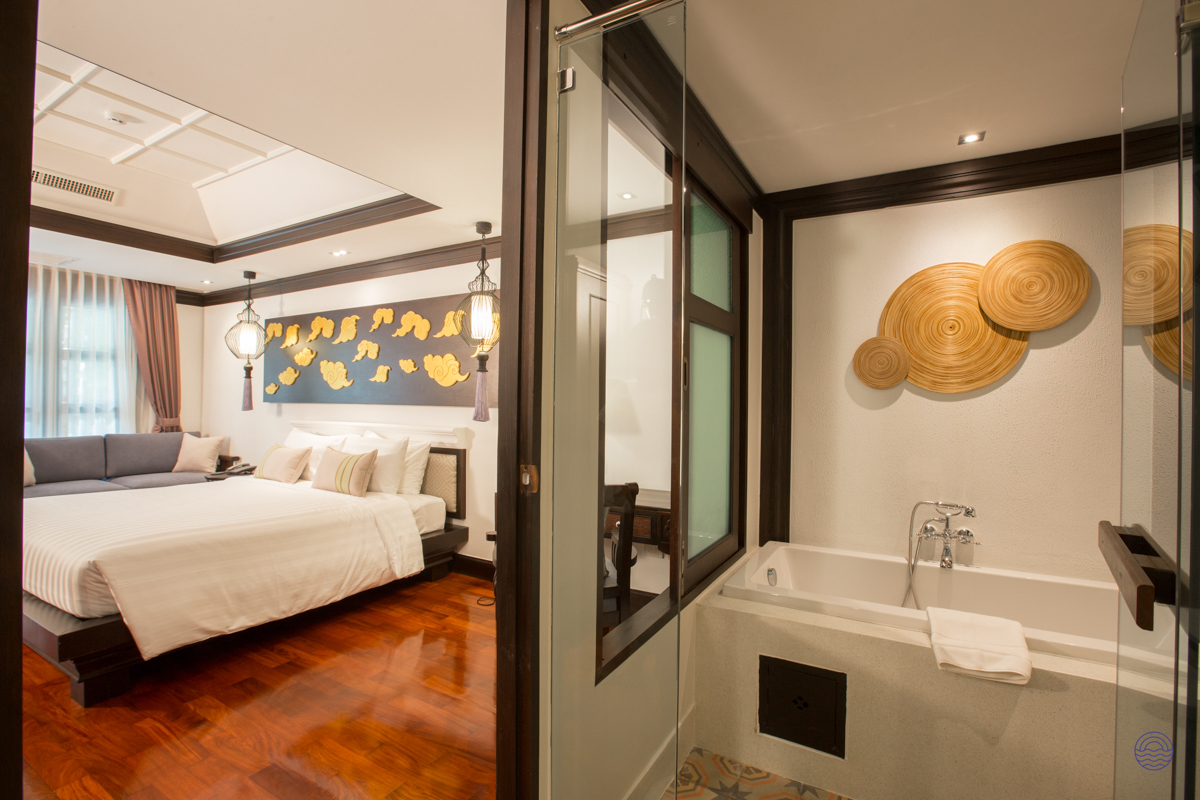 An elegant and serene hotel room in Chiang Mai, featuring a large bed and luxurious bathroom.