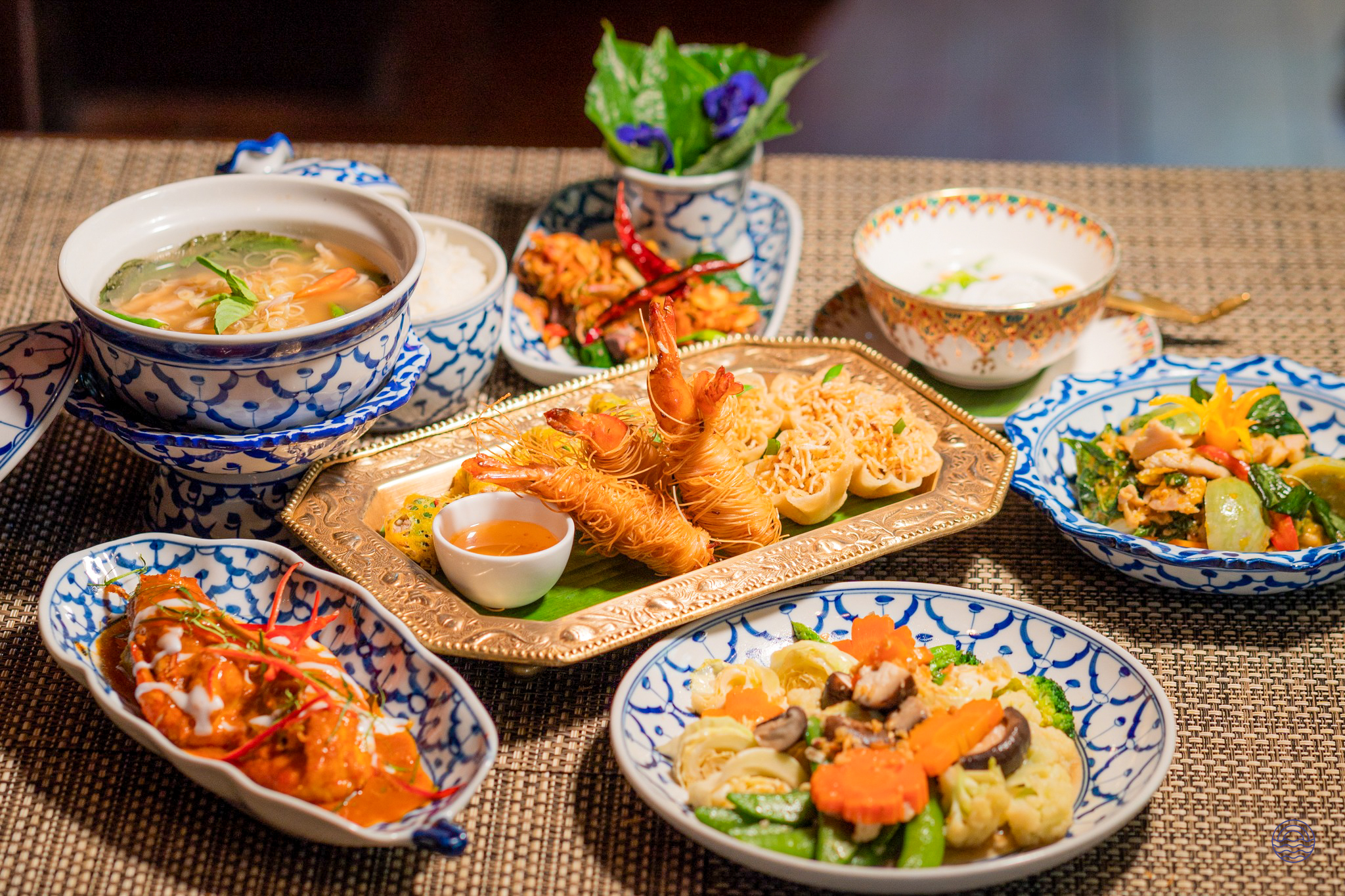 An inviting spread of authentic Thai dishes, including fried shrimp and curries, served for dinner in Bangkok.