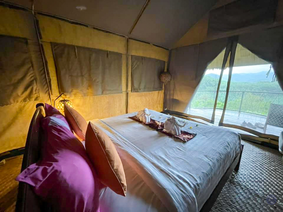 Relax in a spacious glamping tent with a comfortable bed and stunning views of Khao Sok.