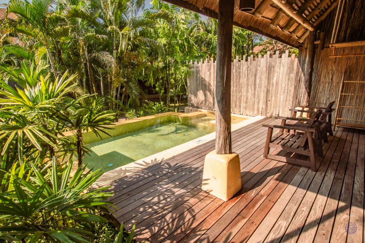 Private pool villa with a wooden deck, small pool, and tropical plants in Koh Kood, Thailand.