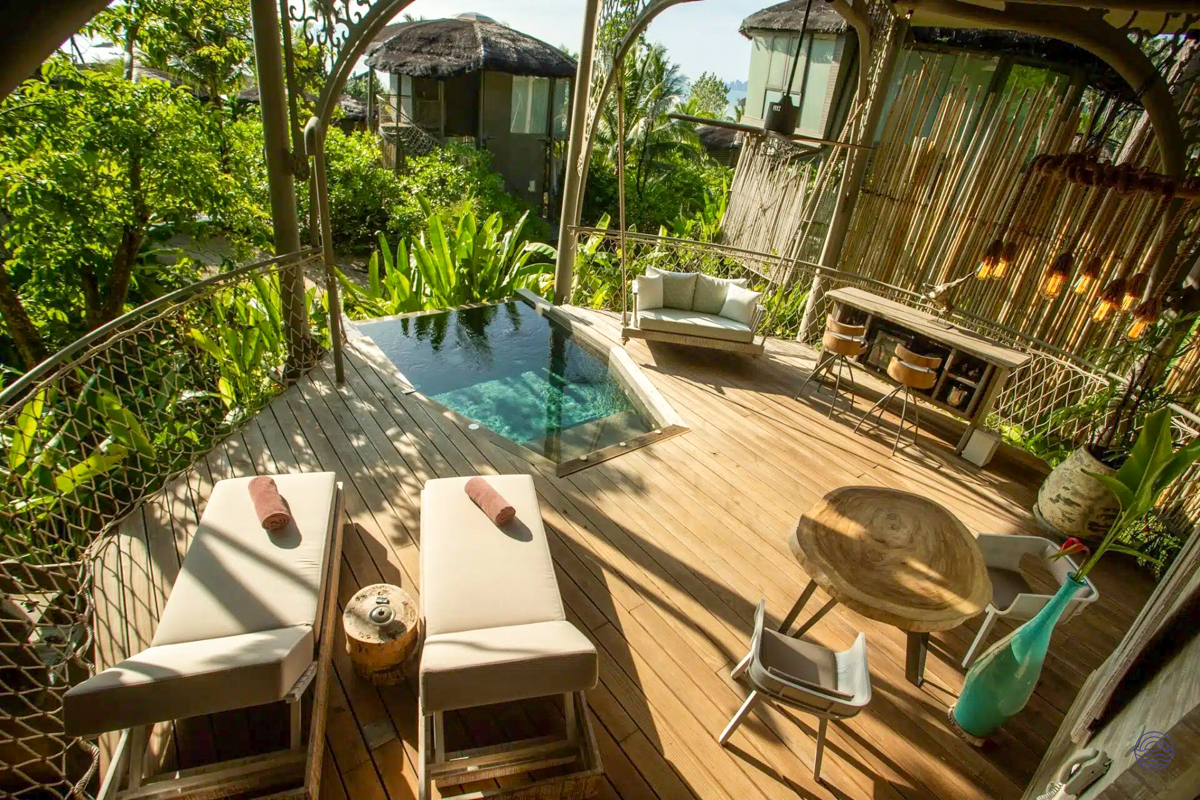 Luxurious treehouse villa deck on Koh Yao Noi with a private plunge pool and sun loungers.