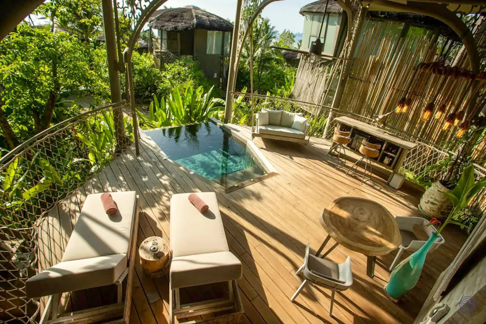 Luxurious treehouse villa deck on Koh Yao Noi with a private plunge pool and sun loungers.