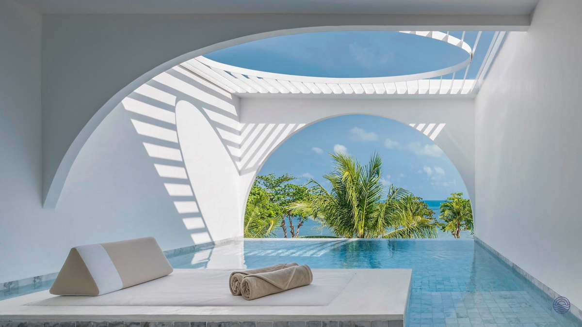 A luxurious private pool villa in Koh Samui with modern white architecture and a stunning ocean view.