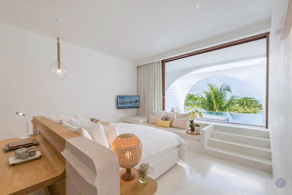 Spacious, modern white hotel room in Koh Samui with a private pool and lush tropical views.