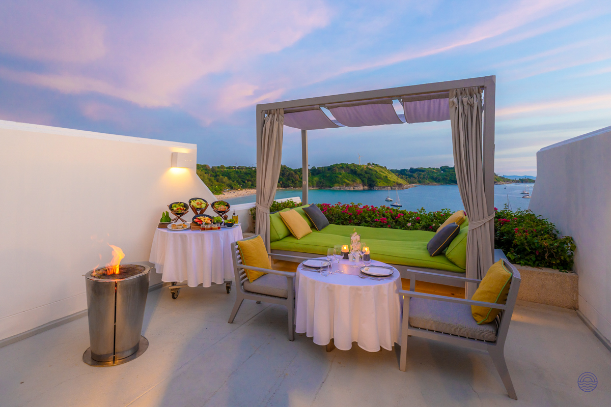 Enjoy a romantic sunset dinner on a luxurious terrace overlooking a beautiful bay in Phuket.