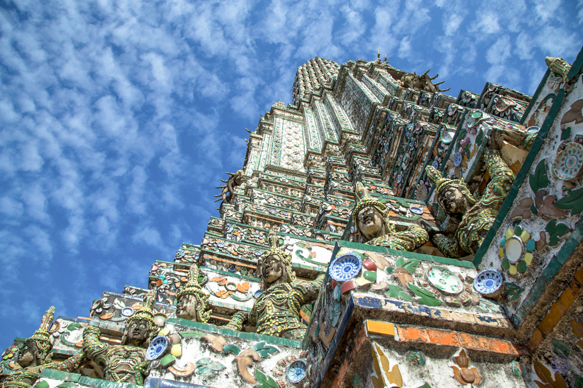 Experience the intricate beauty of Wat Arun temple in Bangkok, adorned with colorful ceramic details.