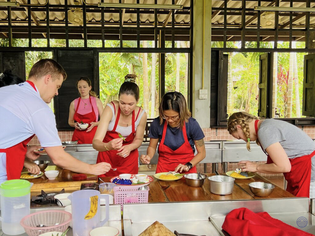 Travelers learn to prepare traditional Thai dishes at an open-air cooking school in Chiang Mai.