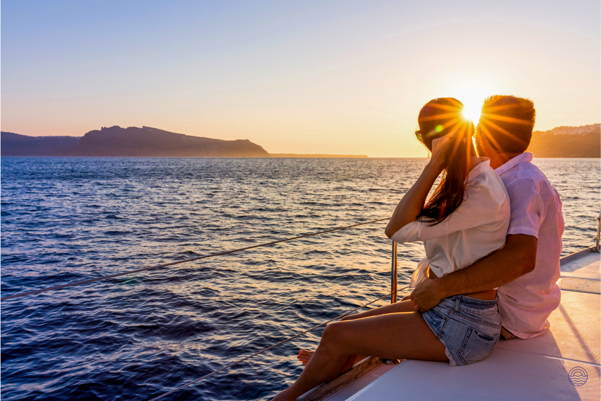 A couple enjoys a romantic sunset cruise over the Andaman Sea near Phuket.
