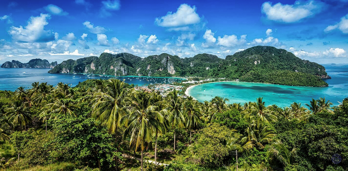 Panoramic view of Koh Phi Phi, featuring lush green islands, white sand beaches, and turquoise bays.