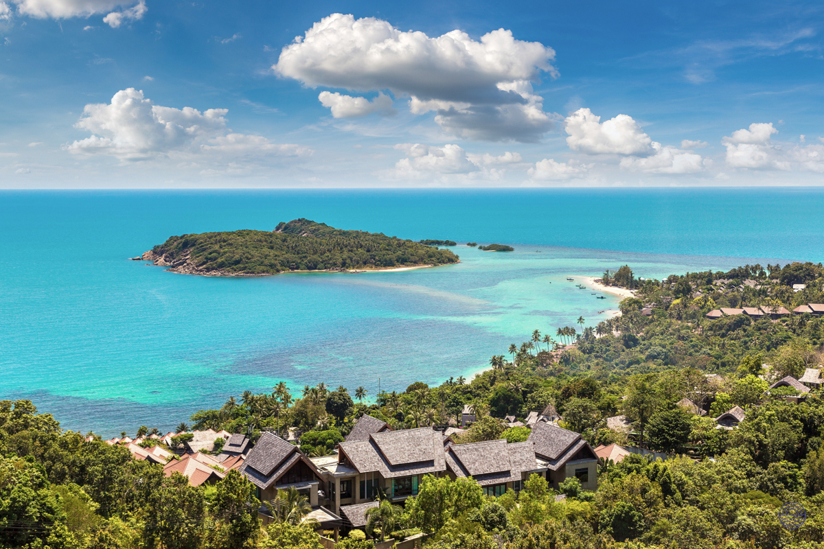 Luxurious resorts overlook the turquoise ocean and a lush island on beautiful Koh Samui.