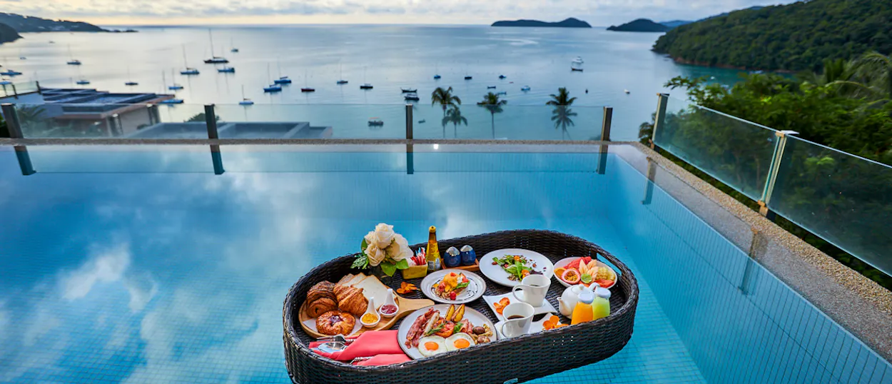 A lavish floating breakfast in an infinity pool overlooking a beautiful bay in Phuket.