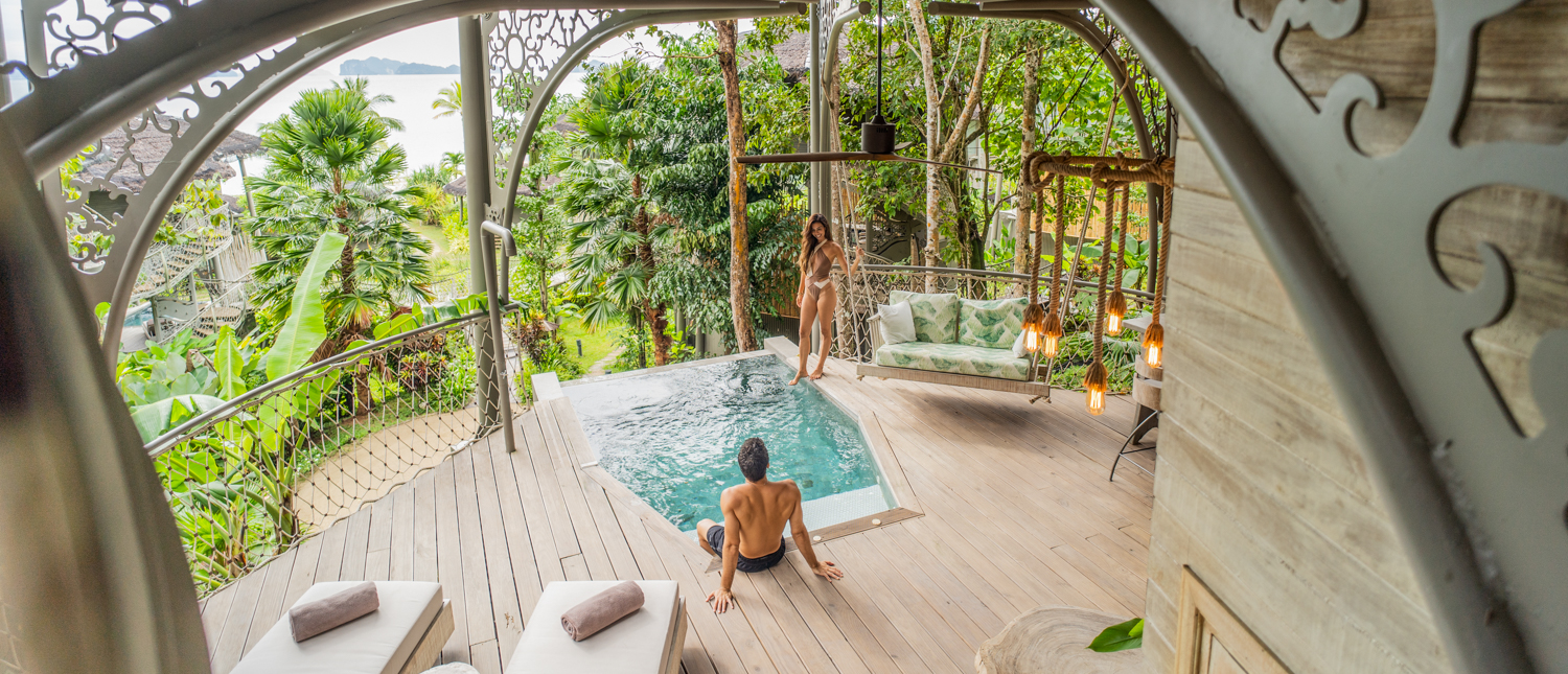 A couple enjoys a private pool on a tropical deck with ocean views at Koh Yao Noi.