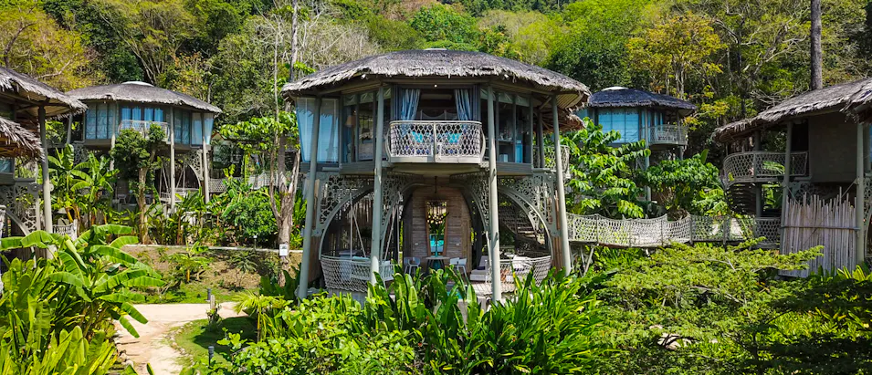 Luxurious treehouse accommodations nestled in lush tropical jungle on Koh Yao Noi, Thailand.