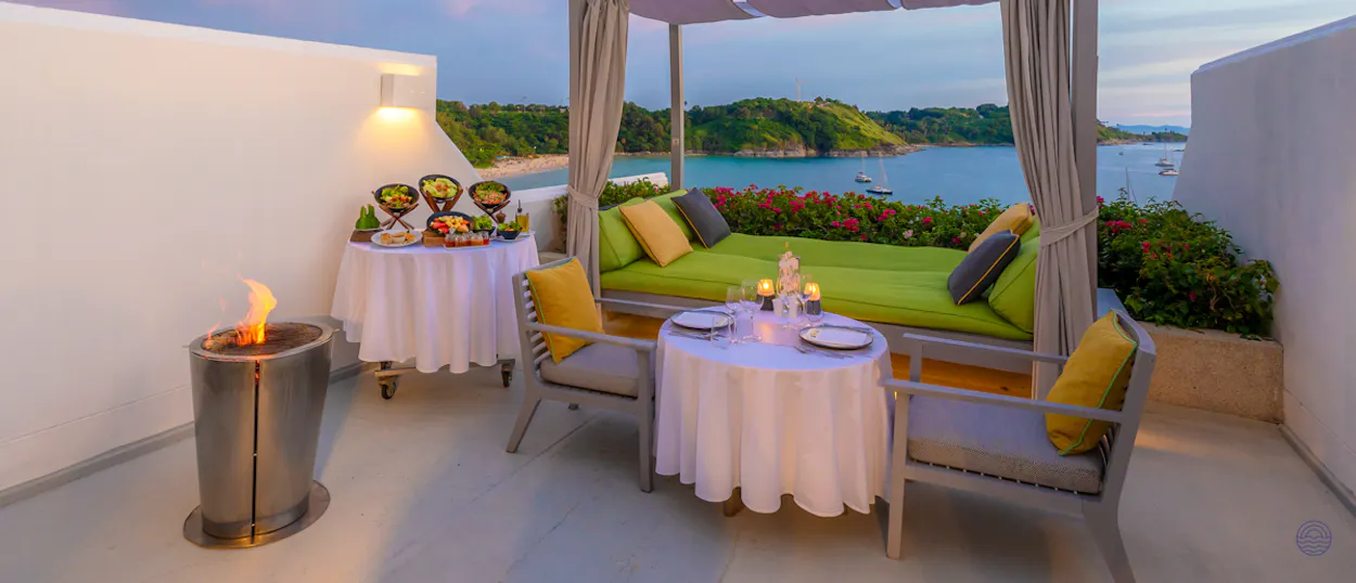Luxurious private terrace in Phuket with a romantic dinner, fire pit, and stunning ocean view.