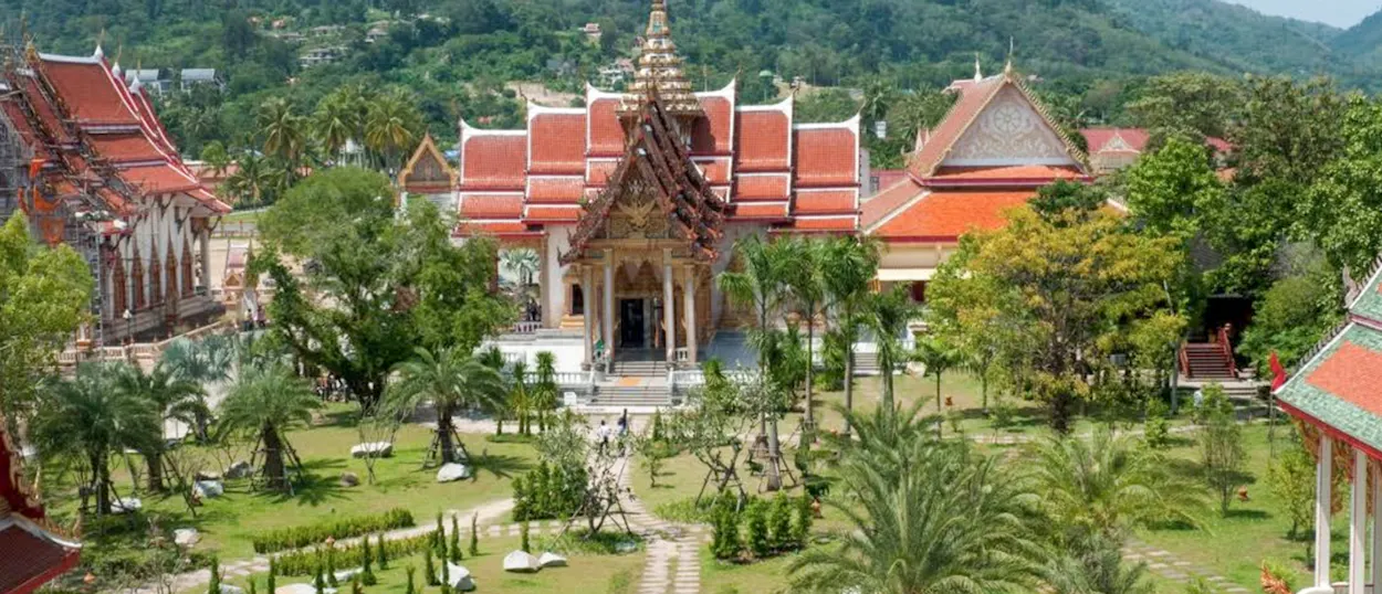 Beautiful temple complex with traditional Thai architecture and serene gardens under sunny skies in Chiang Mai.