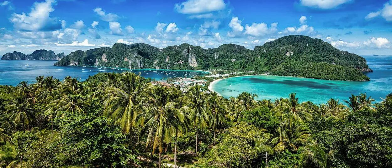 Breathtaking panoramic view of Koh Phi Phi's turquoise bays, sandy beaches, and lush green limestone islands.