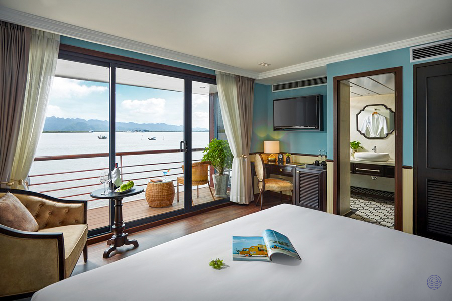 Spacious Capella Cruise Oasis Suite with private balcony overlooking the beautiful waters of Halong Bay.