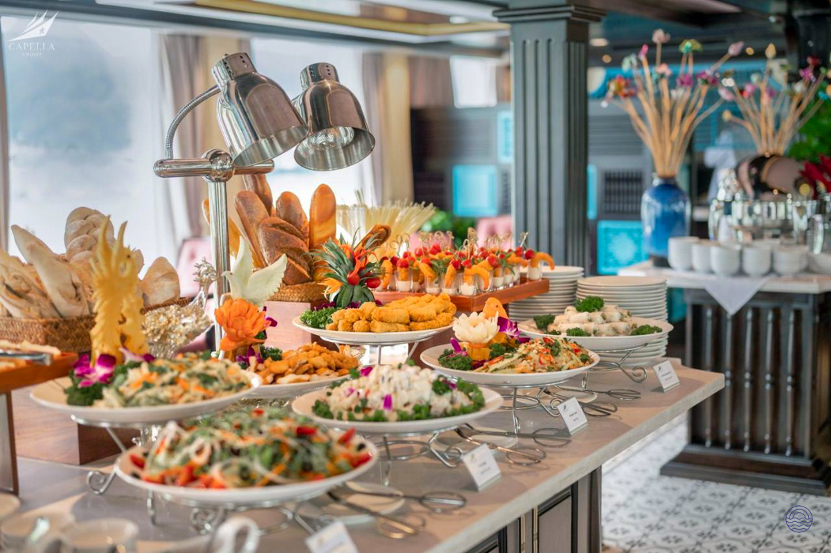 A lavish buffet featuring diverse dishes and fresh bread on a luxurious Halong Bay cruise.