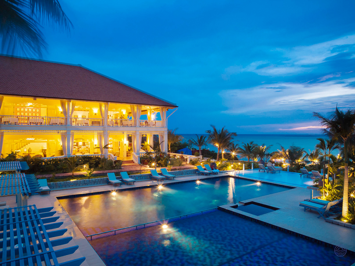 Luxurious La Veranda Resort in Phu Quoc with illuminated pools and ocean view at dusk.