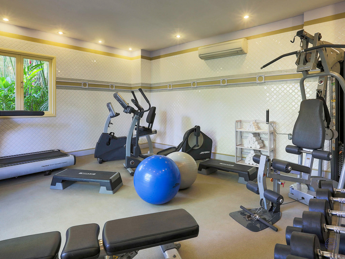 A well-equipped gym at La Veranda Resort in Phu Quoc with various exercise machines and weights.