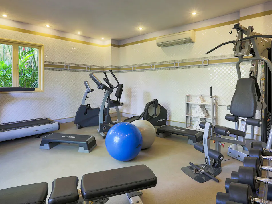 A well-equipped gym at La Veranda Resort in Phu Quoc with various exercise machines and weights.