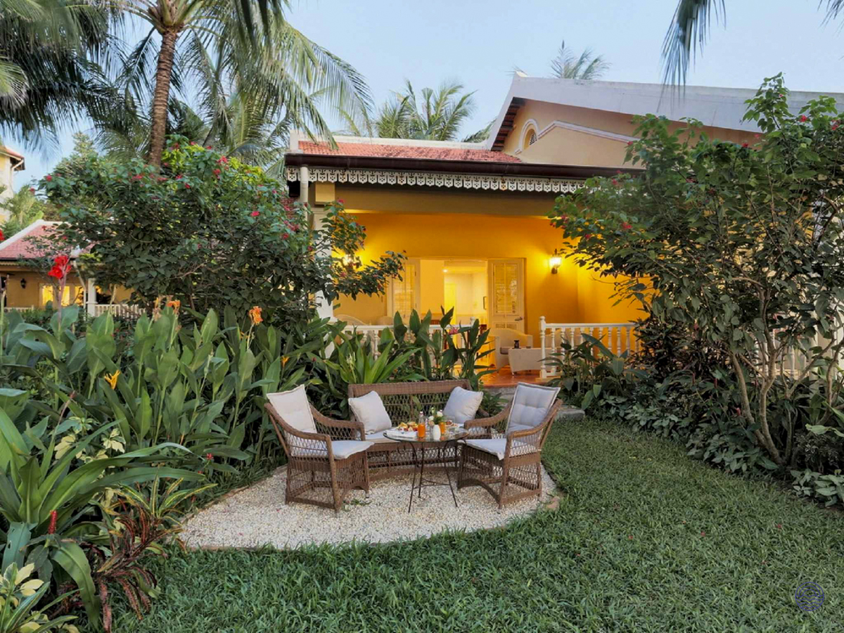 Warmly lit yellow villa with a private garden and outdoor lounge set in Phu Quoc.