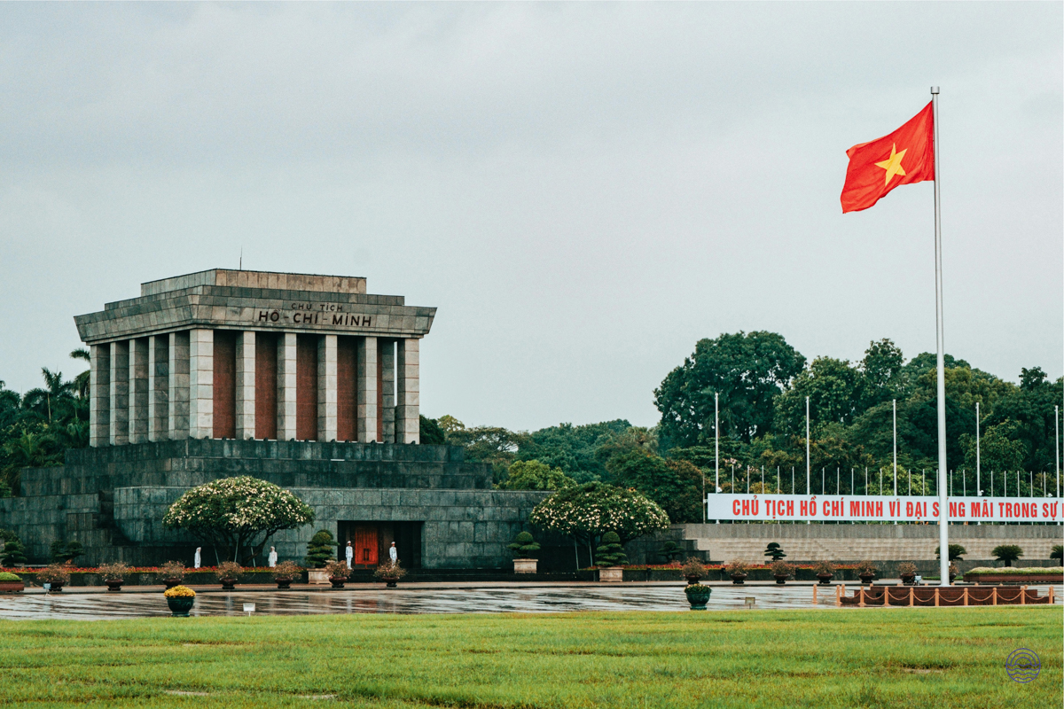 The grand Ho Chi Minh Mausoleum stands prominently in Hanoi, with the Vietnamese flag flying high.