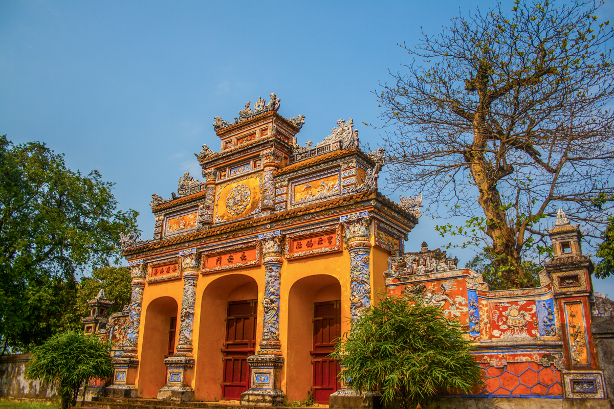 The ornate, multi-tiered gate of Hue's Imperial Citadel, featuring vibrant yellow, orange, and blue details.